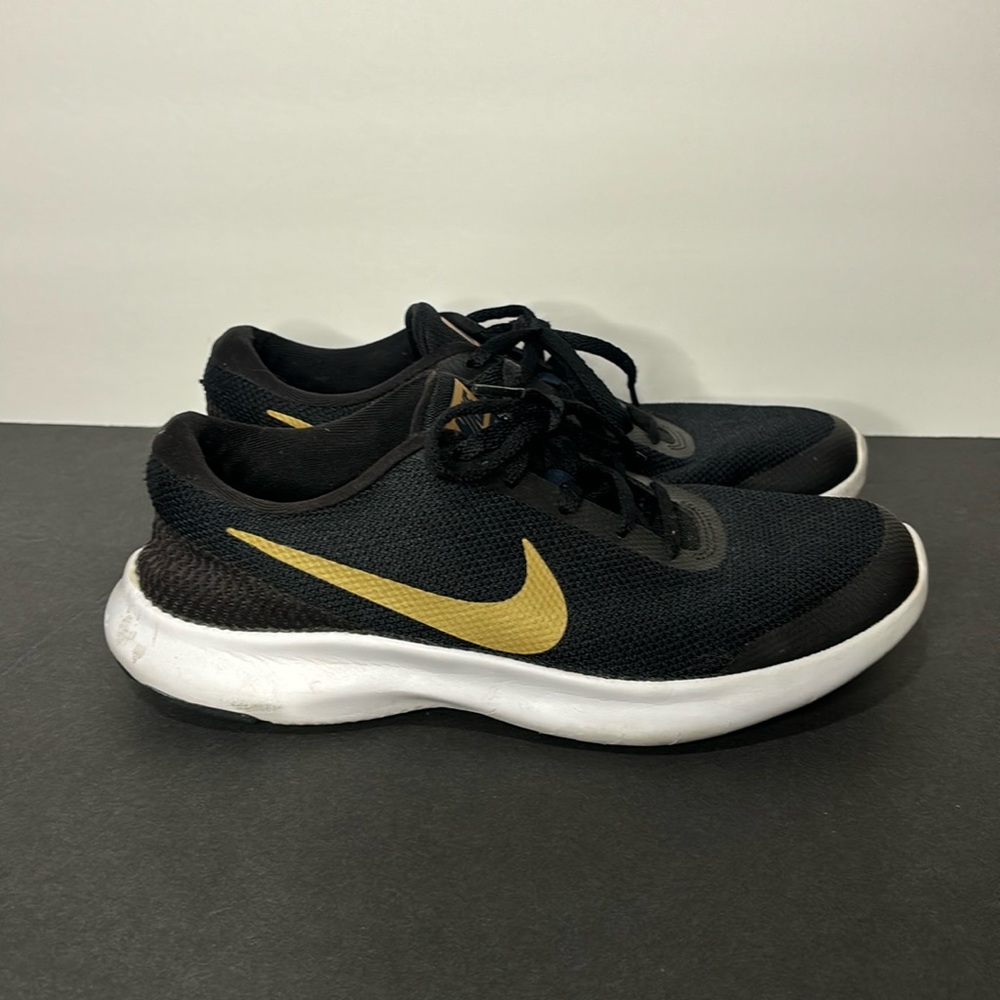 Black and gold Nike tennis shoes